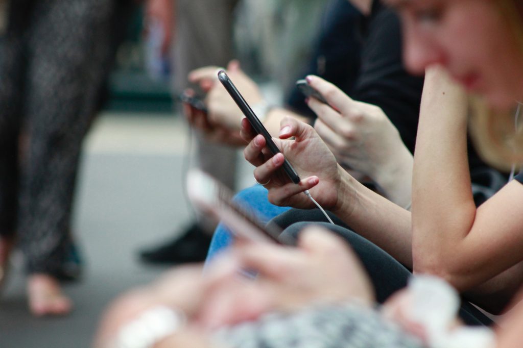 Group of people viewing cell phones