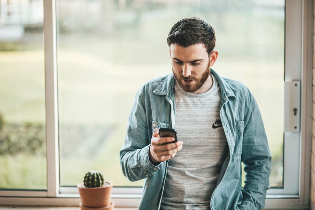 Man casual looking at phone